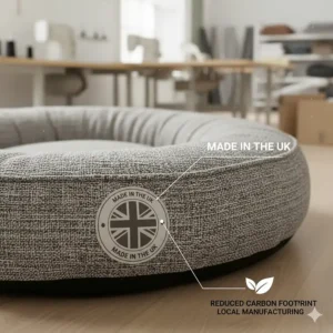 A close-up of a dog bed featuring a Made in the UK label to indicate local manufacturing and a lower carbon footprint.
