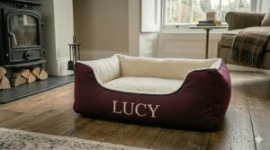 Close-up of high-quality embroidery showing a dog's name on a personalised bed bolster.