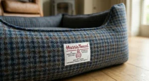 Heritage-style tartan Harris Tweed dog bed complementing elegant living room decor.