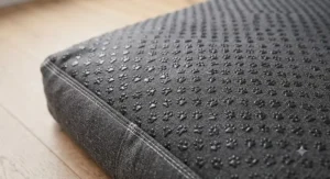 The non-slip rubber grip underside of a reinforced seam dog bed designed for wooden and tiled floors.