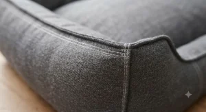 Close-up of heavy-duty double-stitching on a reinforced seam dog bed, highlighting chew-resistant construction.