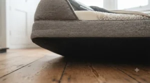 An elderly dog easily stepping into a low-profile dog bed without straining sore hips or arthritis.