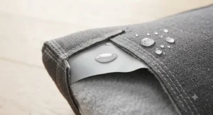 Demonstration of the waterproof internal lining protecting a chew-proof reinforced seam dog bed from accidents.