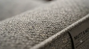 Close-up of tightly woven, hypoallergenic fabric on a dust mite resistant dog bed to prevent allergens.