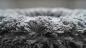 Close-up of soft, shaggy faux-fur fabric on a calming dog bed designed to soothe anxious pets.