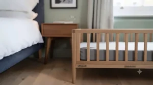 A bespoke wooden bedside dog bed crafted to match standard British oak bedroom furniture.