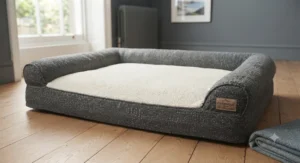 A stylish grey tweed orthopaedic dog bed blending seamlessly with contemporary bedroom furniture.