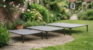 Small, medium, and large sun-safe dog beds lined up on a lawn to show size options for different breeds.