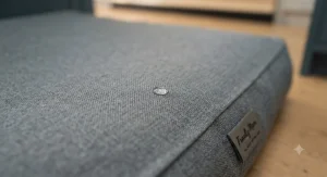 Close-up of the wipe-clean, waterproof fabric on a dog bed designed for busy kitchen floors.
