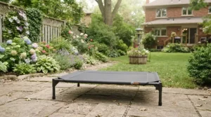An all-weather UV-resistant dog bed for garden use, shown in a vibrant backyard.